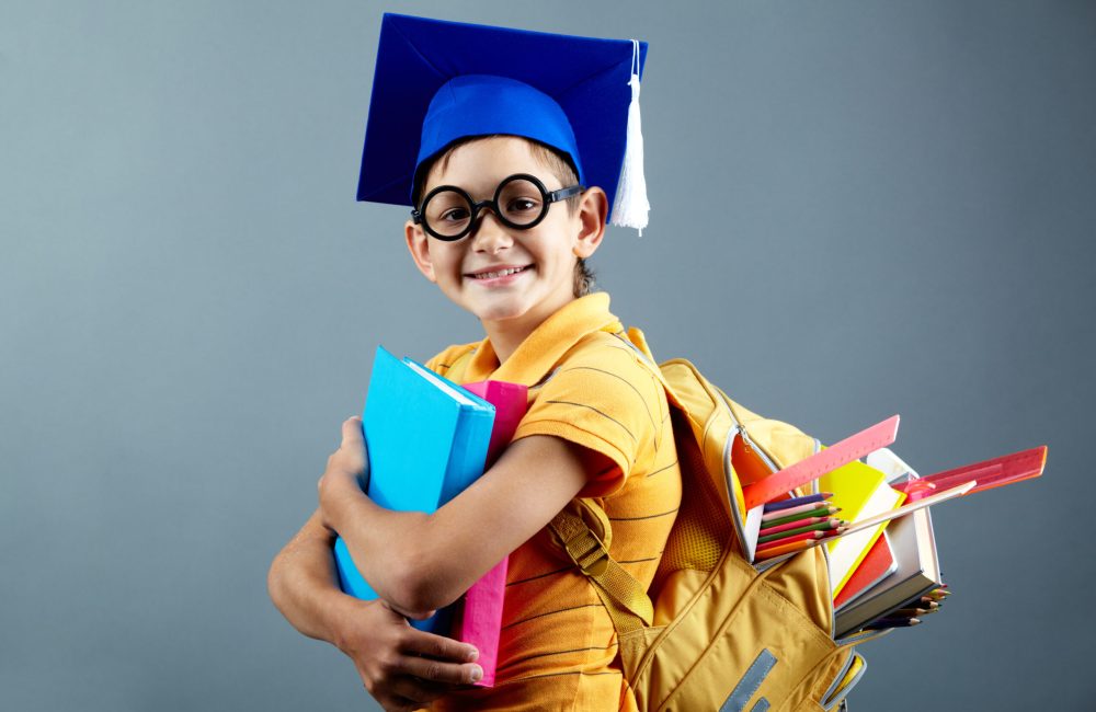 Cute schoolboy Portrait of happy schoolkid with backpack looking at camera